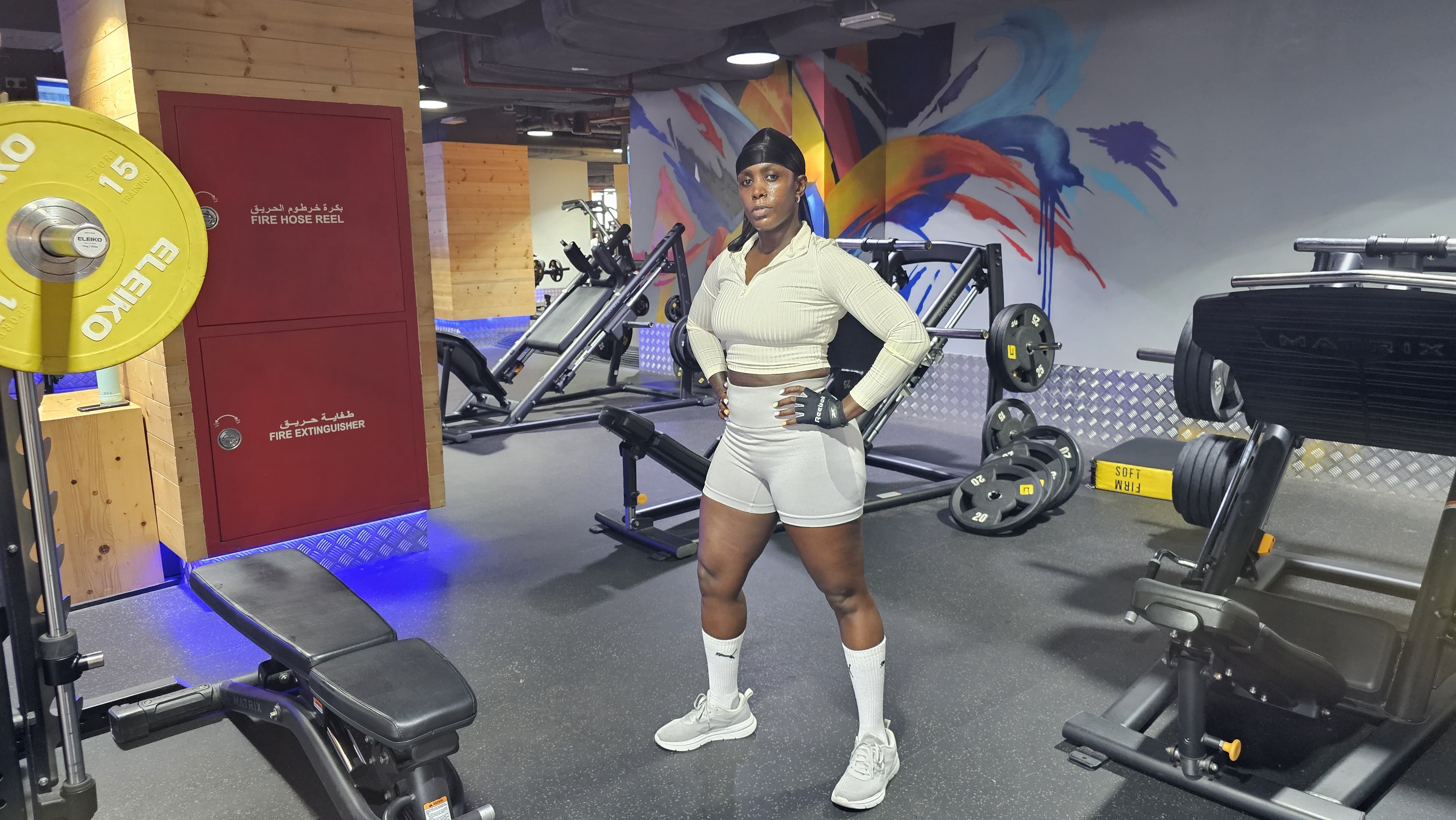 Jojo — Personal Trainer standing confidently in the gym